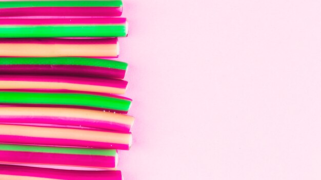 Elevated view of licorice candies on pink backdrop