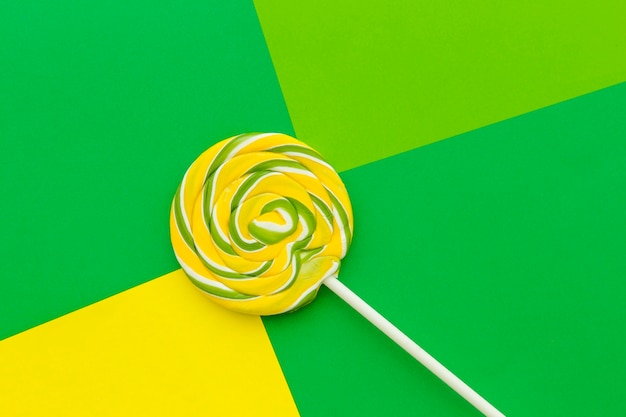 Elevated view of lollipop on colorful background