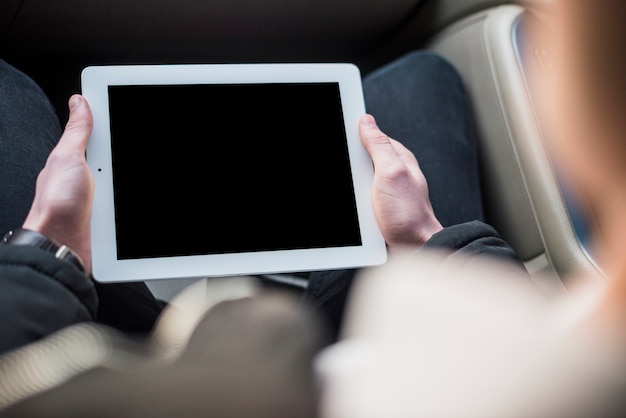 Elevated view of a man using digital tablet with blank screen