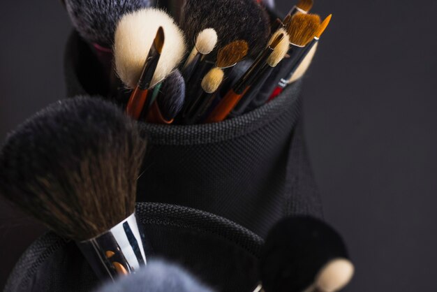 Elevated view of many makeup brushes in holder