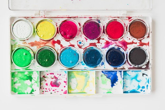 Free photo elevated view of a messy wet water color paint box