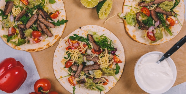 Elevated view of mexican beef stripes with vegetables in tortilla