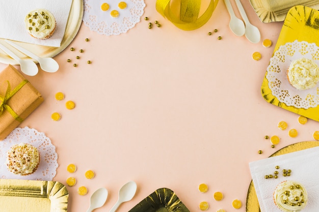 Elevated view of muffins and gifts on colored background