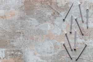 Free photo elevated view of nails on old wooden desk