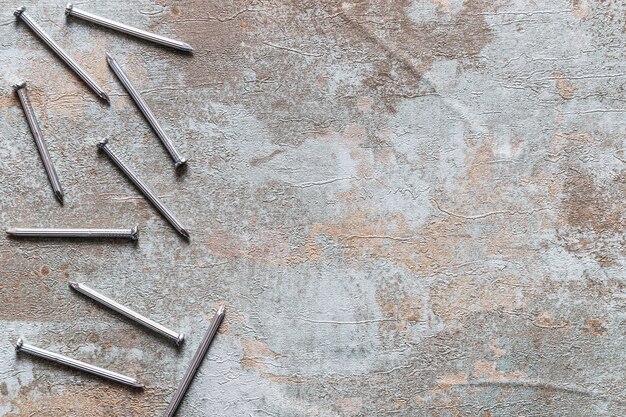 Elevated view of nails on rusty wooden background