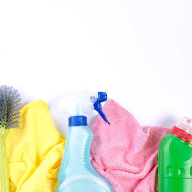 Elevated view of napkins, plastic bottles and brush on white backdrop