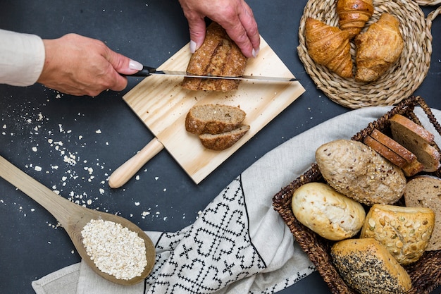 Elevated view of a person's hand slicing bread with knife