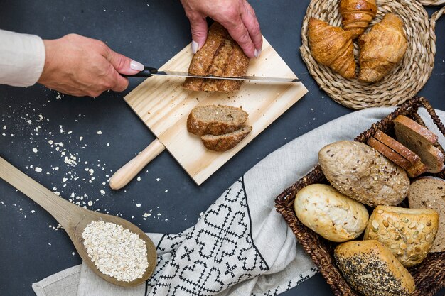 Elevated view of a person's hand slicing bread with knife
