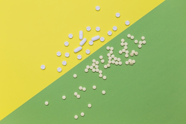 Elevated view of pills on dual colored background