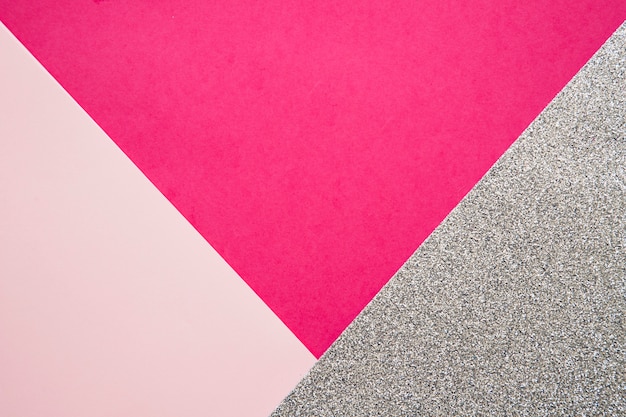 Elevated view of pink and magenta cardboard papers on grey surface