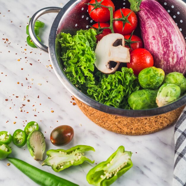 Elevated view of raw healthy vegetables on marble backdrop