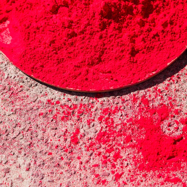 Free photo an elevated view of red holi color over the large plate