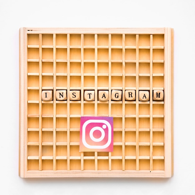 Free photo elevated view of scrabble wooden game with instagram word and icon