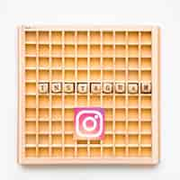 Free photo elevated view of scrabble wooden game with instagram word and icon