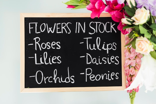 Elevated view of slate showing various flowers in stock