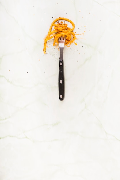 Elevated view of spaghetti pasta rolled on fork