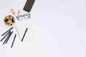 Free photo elevated view of stationeries and eyeglasses on white background