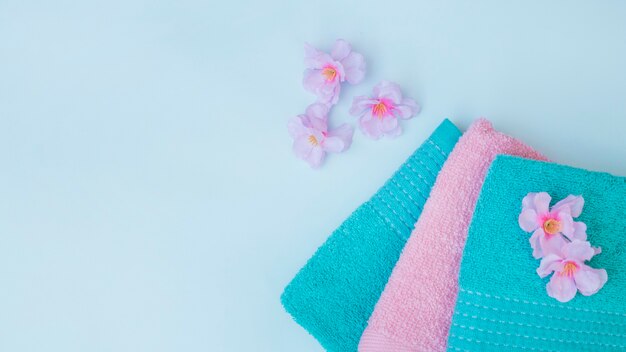 Elevated view of towels; with purple flowers on blue background