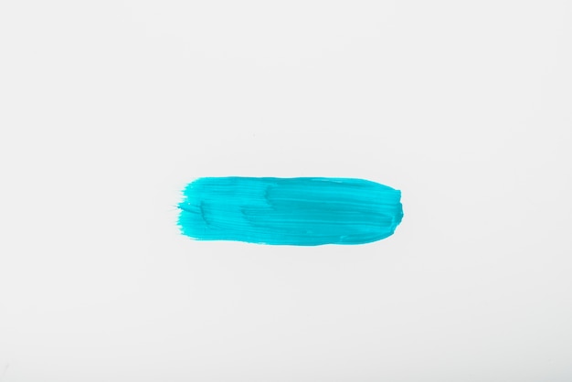 Free photo elevated view of turquoise watercolor brush stroke on white sheet of paper