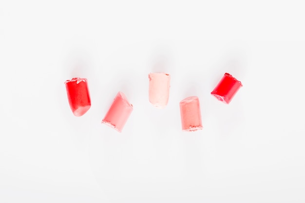 Free photo elevated view of various lipsticks on white background