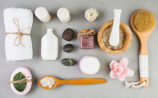 Elevated view of various spa products forming frame on grey backdrop