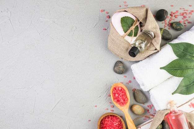 Elevated view of various spa products on grey backdrop