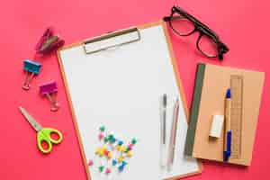 Free photo elevated view of various stationeries on pink background