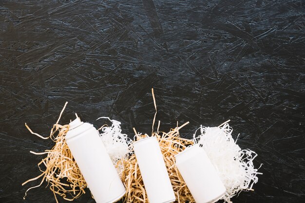 elevated view of white bottles on woodshave