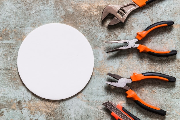 Elevated view of white circular frame besides various worktools