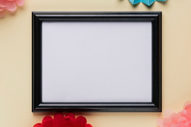 Free photo elevated view of white empty frame on beige backdrop