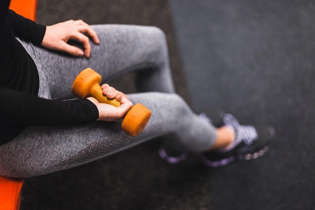 Free photo elevated view of a woman's hand exercising with dumbbell