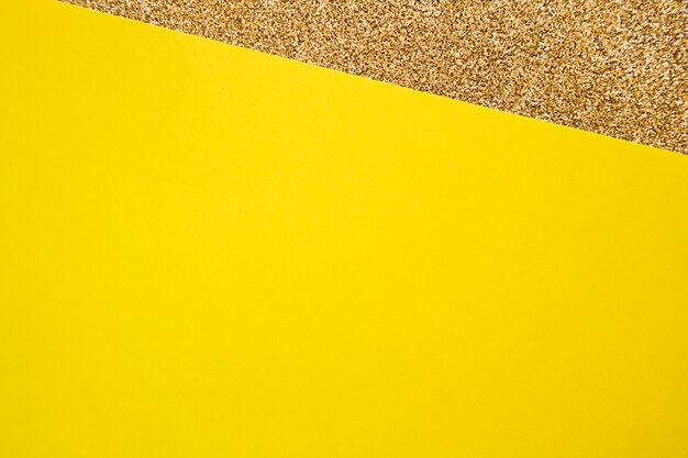 Elevated view of yellow cardboard paper on golden carpet