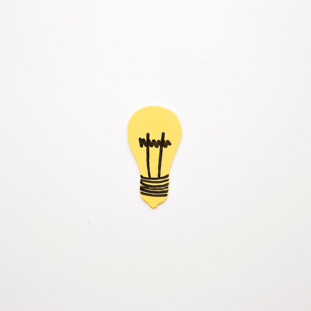 Free photo elevated view of yellow light bulb on white background