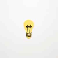 Free photo elevated view of yellow light bulb on white background