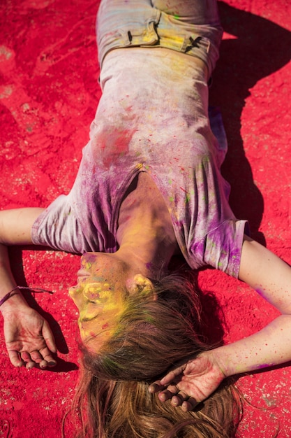 An elevated view of young women lying on holi color