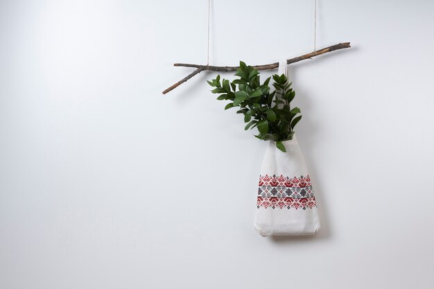 Embroidered bag hanging on branch