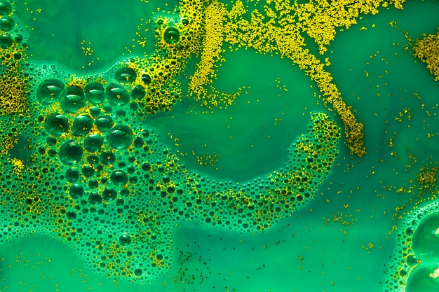 Free photo emerald stiff paint with blobs and gold crumbs