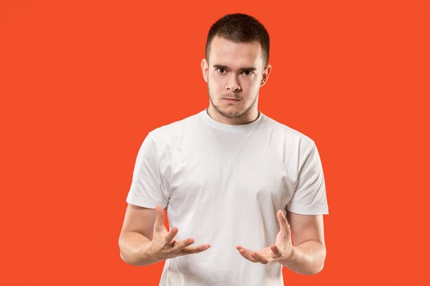 Emotional angry man on studio background. Emotional, young face. male half-length portrait.  