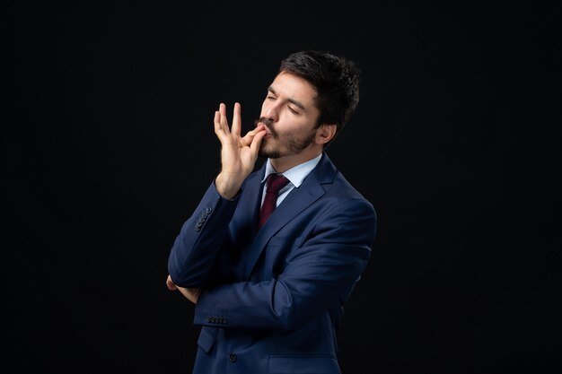 Emotional bearded man making perfect gesture on isolated dark wall