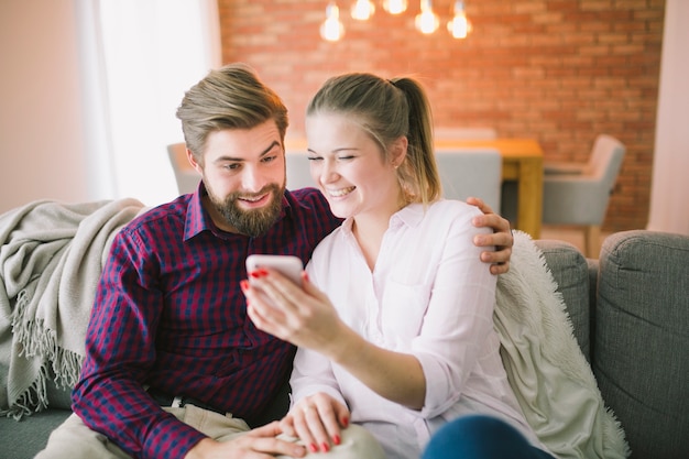 Emotional couple with smartphone