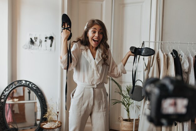 Emotional lady holding shoes