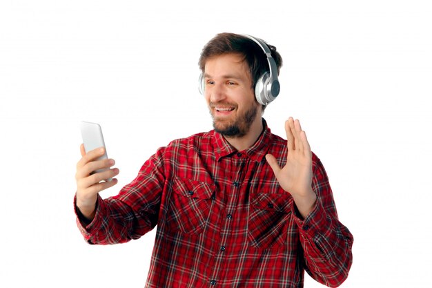 Emotional man using smartphone isolated on white studio
