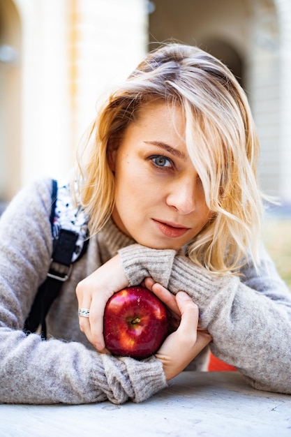emotional portrait of a young woman with an apple