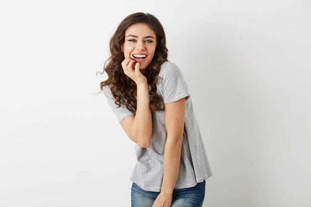Emotional positive young woman laughing sincerely, natural look, smiling happy, curly hair, face expression, posing  isolated, summer casual style, white teeth, hipster style