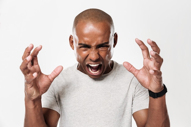 Free photo emotional screaming young african man