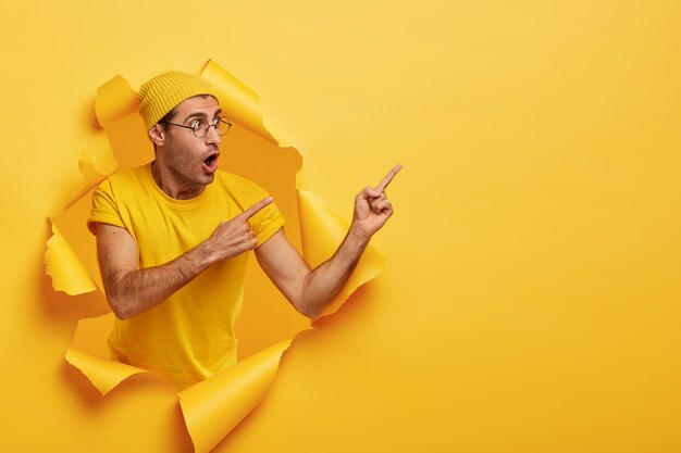 Emotional surprised stylish man wears yellow hat