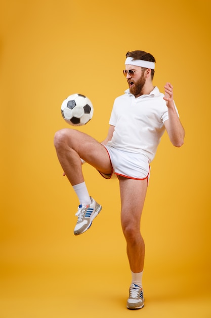 Emotional young sportsman make sport exercises. Looking aside.