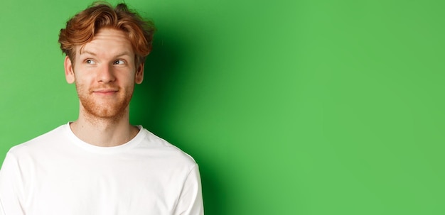 Free photo emotions and fashion concept closeup of handsome redhead male model with beard and messy haircut loo