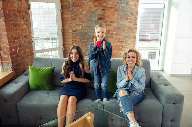 Emotions. Mother, son and sister at home having fun. Holidays, family, comfort, cozy concept, celebrating birthday. Beautiful caucasian family. Spending time together, playing, laughting greeting