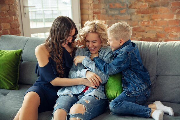 Emotions. Mother, son and sister at home having fun